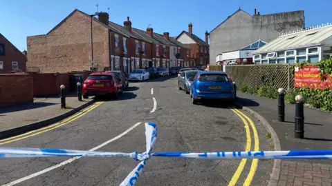 Police tape across a Normanton street