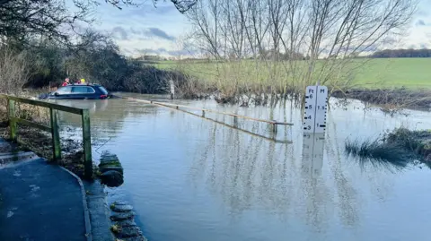 Essex County Fire & Rescue Service A car flooded at Buttsbury Wash near Billericay