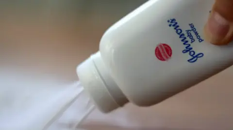 Getty A Johnson & Johnson bottle shown pouring out talcum powder on a table