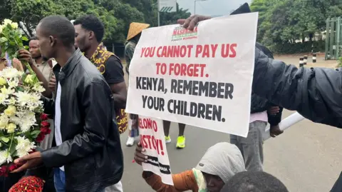 Protesters holding placards on Nairobi streets 