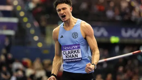 PA Media Great Britain’s Joel Clarke-Khan competing in the men’s high jump on day two of the Novuna UK Athletics Indoor Championships. He is clenching his fists as he celebrates.