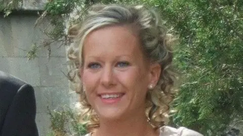 Met Police Gillian Morand stands outside in front of a tree. She has blonde curly hair.