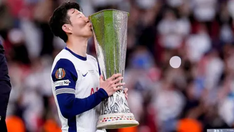 Son Heung-min kisses the Europa League trophy