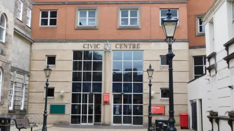 LDRS The front of Stoke on Trent city council's civic centre. it has large windows with a glass door.