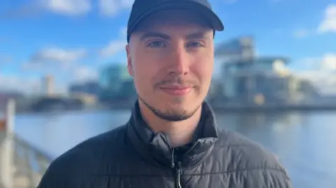 Hair loss drug finasteride 'largest mistake of my life' Kyle Kyle stands outside, next to the canal, looking towards the camera