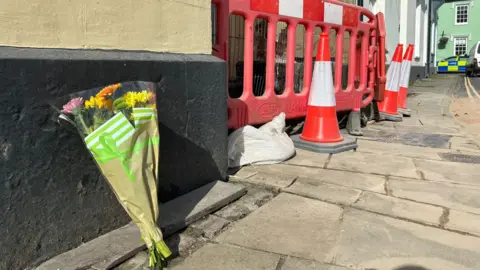 Flowers laid at the scene of the crash