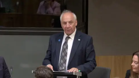 Mike Hedges asking a question in the Senedd