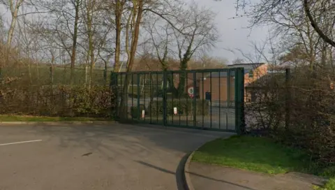 Street view of green school gates in Eckington.