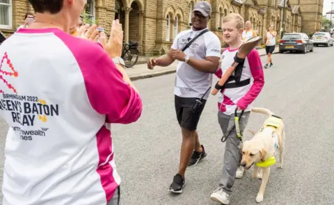 Getty Images Louis Moorhouse takes part in The Queen's Baton Relay as it visits Bradford