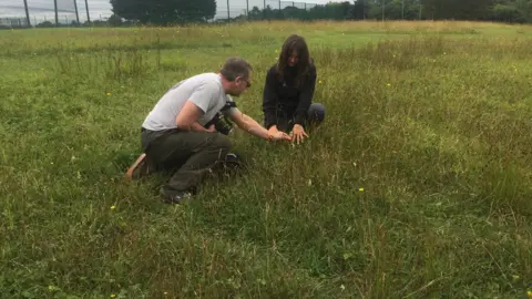 Project co-ordinator Rachel Conway and orchid expert Sean Cole examine one of the flowers