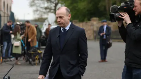 PA Media Chris Heaton-Harris speaking to the media after meeting the main Stormont parties