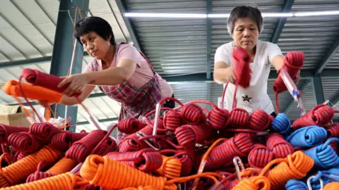 Getty Images Workers speed up production of sports rope net orders at a workshop of a sports rope net production enterprise in Lizhuang town, Huimin county, Binzhou City, Shandong Province, China, Aug 15, 2022.