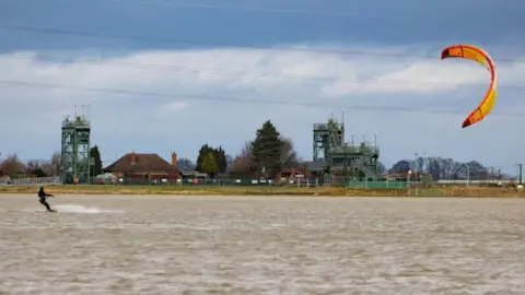 Terry-Harris.com Kite surfer on a flooded field