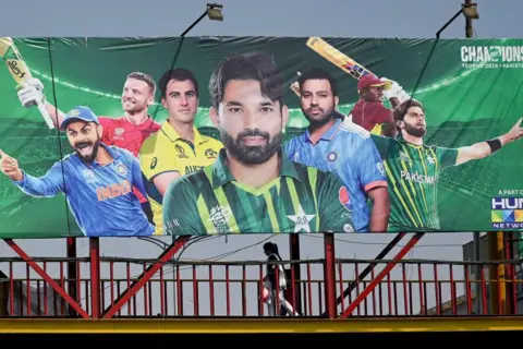 AFP Sebuah papan iklan menggambarkan kapten kriket India Rohit Sharma (2L) di depan Champions Trophy di Lahore pada 15 Februari 2025