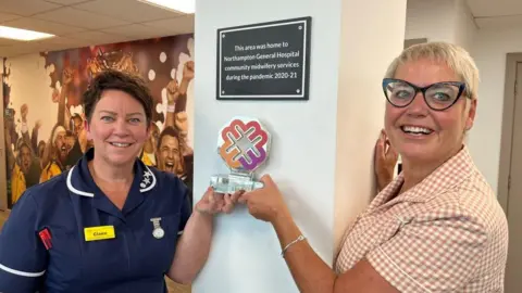 Oliver Conopo/BBC Midwives Claire Dale and Anne Richely posing with the plaque.