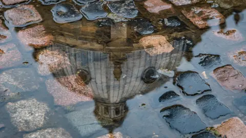 Anthony P Morris Radcliffe Camera reflected in puddle