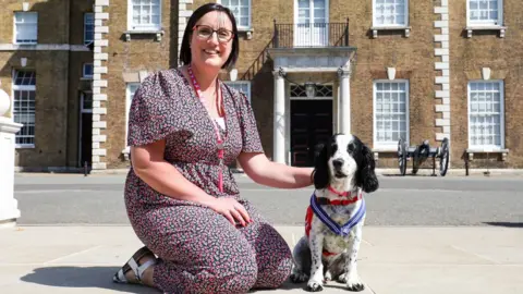 PA Media Michelle Sutherland and Clive the cocker spaniel