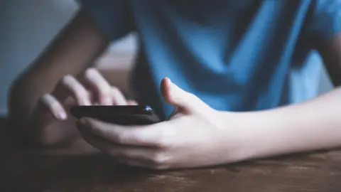 Getty Images Boy using phone