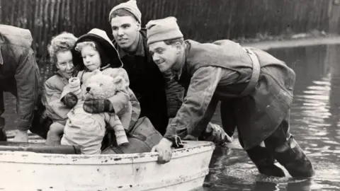 Courtesy of Canvey Community Archive Sylvia Stone and her mother being rescued on Canvey Island