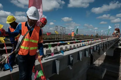 YASUYOSHI CHIBA Chinese workers stand at the construction site of Standard Gauge Railway (SGR) during the presidential inspection of the SGR Nairobi-Naivasha Phase 2A project in Nairobi, Kenya, on June 23, 2018.