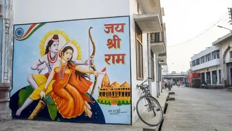 Getty Images A mural depicting Hindu gods Rama, left, and Sita is displayed on a wall in Ayodhya, Uttar Pradesh, India, on Friday, Jan. 18, 2019.