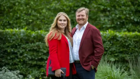 Getty Images King Willem-Alexander of the Netherlands (R) and Princess Amalia pose during the summer photo session at Huis ten Bosch Palace in The Hague, on July 16, 2021