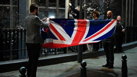 Getty Images The UK flag is taken down and folded up outside the European Parliament building in Brussels.