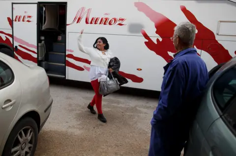 Getty Images A farmer watches the women arrive