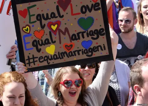 Getty Images A sign from a pro-gay marriage march in Belfast saying: "equal love, equal marriage"