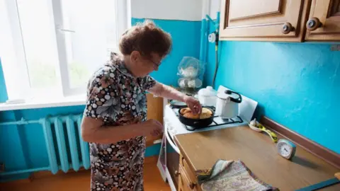 Getty Images Elderly woman cooking