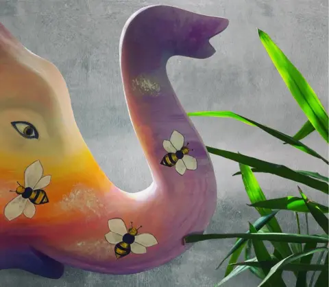 Sarah Harrison The trunk of a painted elephant with bees on it