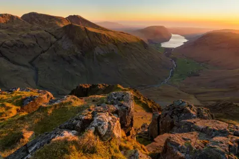 Getty Images View looking down over Scafell Pike and Wastwater to the coast at sunset