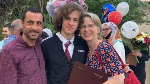 The Awartani Family Hisham Awartani (middle) with his mother and father