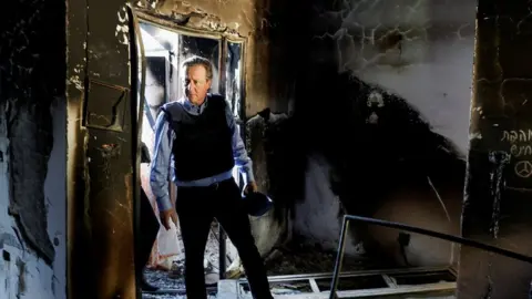 Reuters Lord Cameron is shown some of the destruction caused by a Hamas attack on a kibbutz