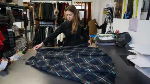 Getty Images Bogdana Karlova working at a tartan company in Keith in May, after arriving in Scotland in March