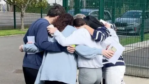 BBC Students group hug after getting A-level results