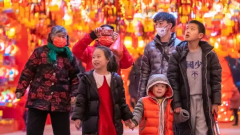 Getty Images People look at illuminated lanterns during a lantern show at a tourist attraction ahead of the Chinese New Year, the Year of the Rabbit, on January 19, 2023 in Yuncheng, Shanxi Province of China.