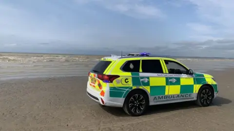 South East Coast Ambulance Service Secamb staff on Camber Sands beach