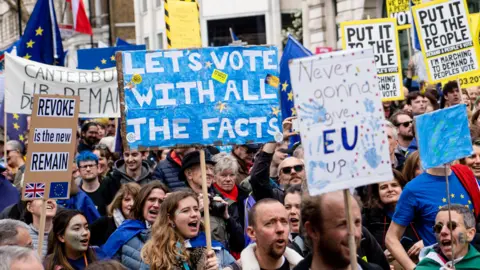AFP People hold placards during Saturday's pro-EU march through London organised by the People's Vote campaign