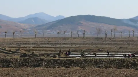 WFP People work in bare fields in North Korea