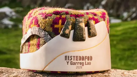 Eisteddfod The Eisteddfod Crown on a log perched outside.