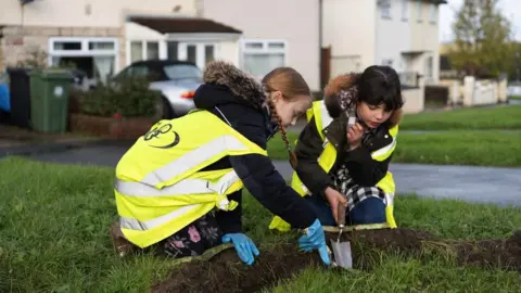 Rachel Palmer Image of children planting flowers