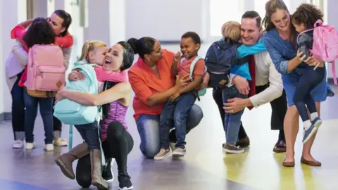 Getty Images Parents collecting children