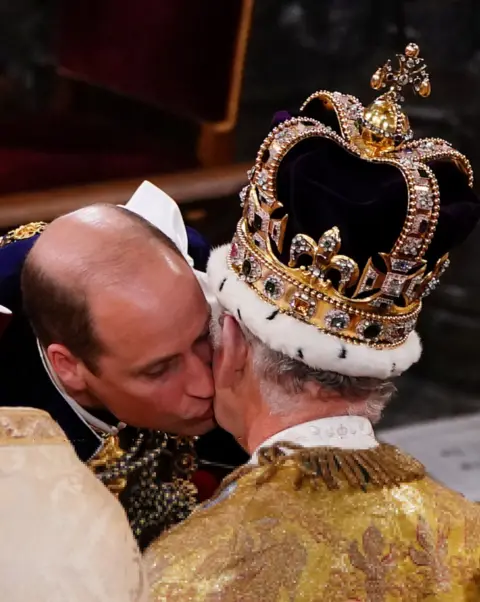 Reuters Prince William kisses King Charles's cheek as he pays homage to his father