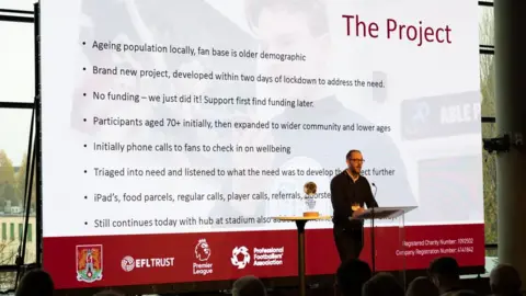 EFDN Conference Phill Smith, Chief Executive of the Northampton Town Community Trust on stage