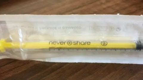 Needle saying "never share"