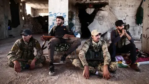 AFP Rebel fighters from the Nur al-Din al-Zinki faction rest in rebel-held Aleppo province (23 September 2018)