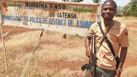 Arouna Louré Dr Arouna Louré holding a gun during his three-month army deployment in Burkina Faso