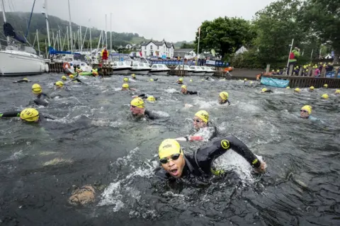 Danny Lawson/PA Wire Swimmers take part in the Great North Swim on Lake Windermere in Cumbria Saturday June 11, 2016.