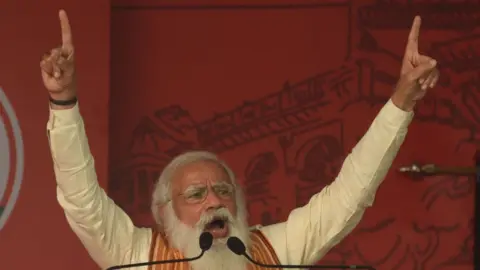 Getty Images Prime Minister Narendra Modi addresses a public rally for West Bengal Assembly Election at Barasat on April 12, 2021 in North 24 Parganas, India